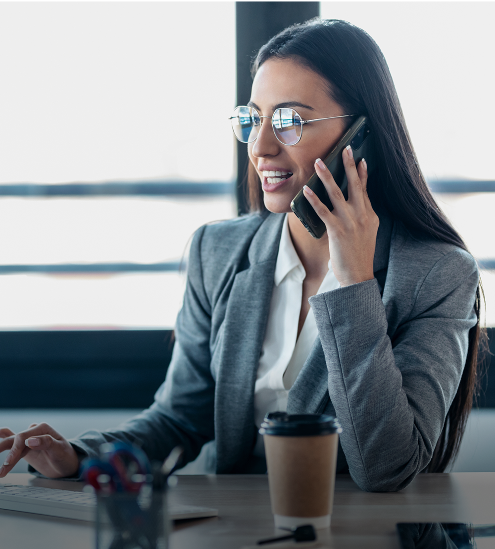Business-Woman-at-Desk-on-Phone-Call